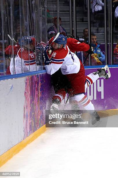 Ondrej Palat of Czech Republic checks Julien Vauclair of Switzerland during the Men's Ice Hockey Preliminary Round Group C game on day eight of the...