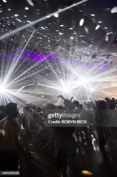 Festival-goers dance to electronic music in the Yuma tent on day three of the Coachella Music Festival in Indio, California on April 12, 2015. AFP...