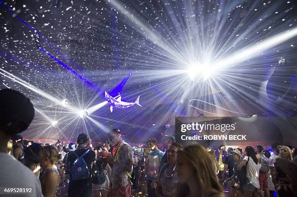 Festival-goers dance to electronic music in the Yuma tent on day three of the Coachella Music Festival in Indio, California on April 12, 2015. AFP...