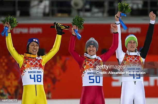 Silver medalist Noriaki Kasai of Japan, gold medalist Kamil Stoch of Poland and bronze medalist Peter Prevc of Slovenia celebrate on the podium...
