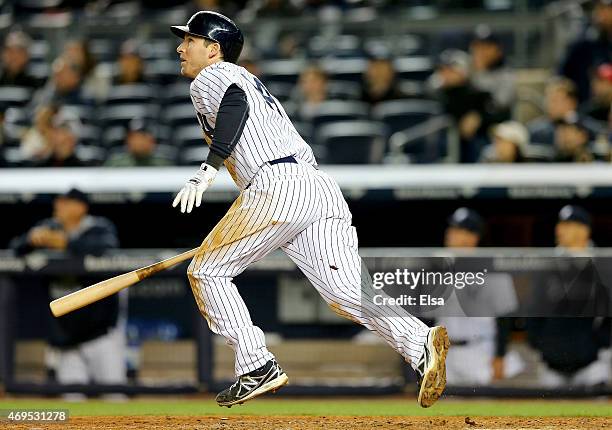 Stephen Drew of the New York Yankees hits a SAC fly in the sixth inning against the Boston Red Sox on April 12, 2015 at Yankee Stadium in the Bronx...