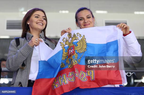 Former rhythmic gymnast Alina Kabayeva and pole vaulter Yelena Isinbayeva of Russia attend the Men's Ice Hockey Preliminary Round Group A game...