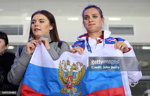 Former rhythmic gymnast Alina Kabayeva and pole vaulter Yelena Isinbayeva of Russia are upset after the Men's Ice Hockey Preliminary Round Group A...