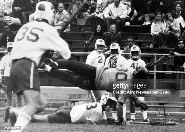 John Kaestuser, who played attack for the University of Maryland, and Karl Schwelm, defence for Navy, colliding at midfield during a lacrosse game,...