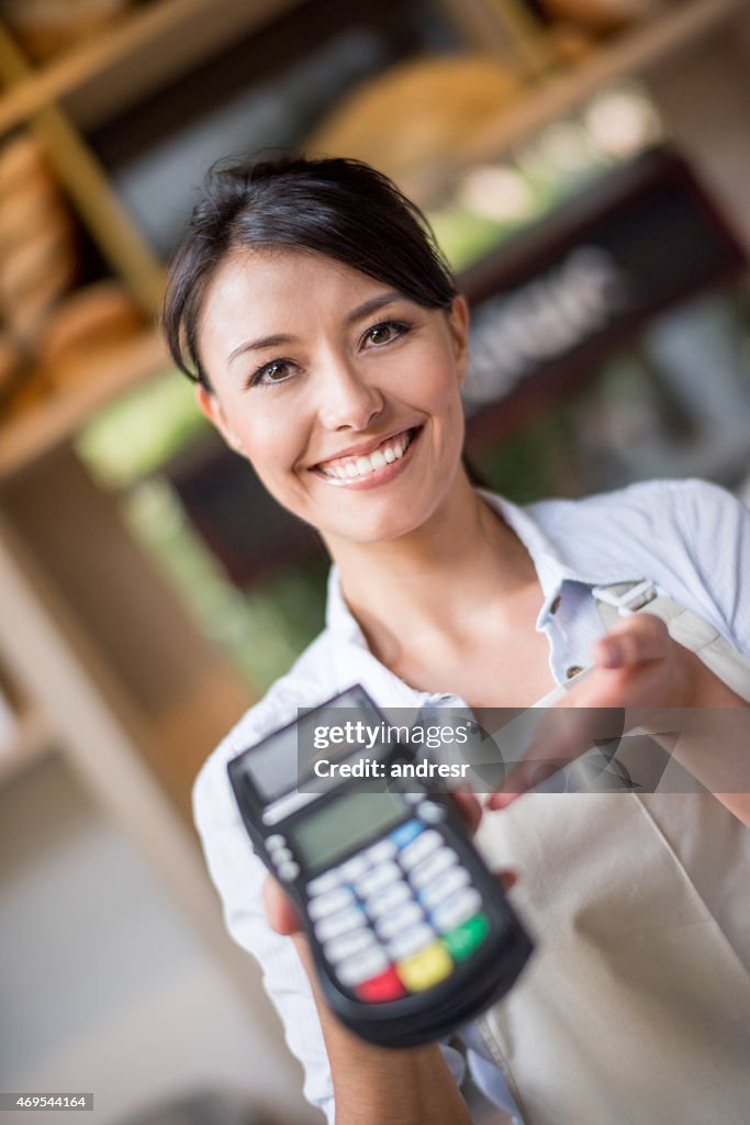 Waitress holding a credit card machine