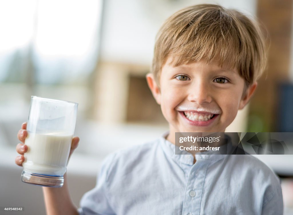 Boy drinking milk and leaving a mustache