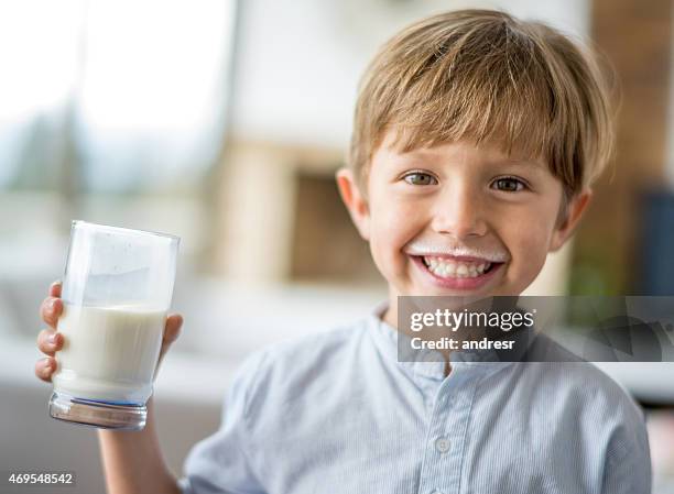 boy drinking milk and leaving a mustache - one boy only stock pictures, royalty-free photos & images