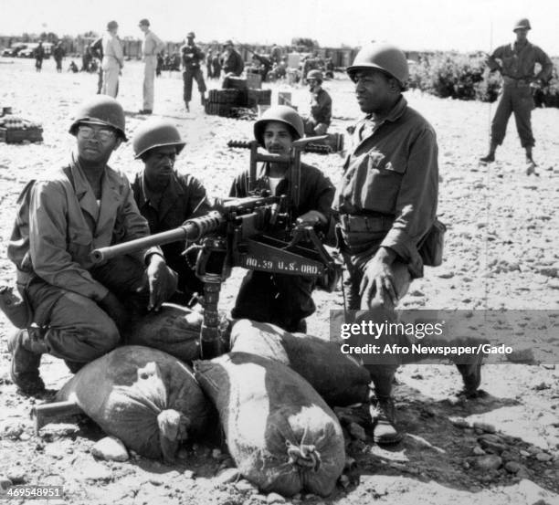 Members of Virginia's 466th Anti Aircraft Artillery Automatic Weapons Reserve Battalion take a break from operating a 50 calibre machine gun at...