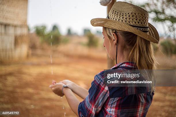 young cow girl in farm land-raining - caught in rain stock pictures, royalty-free photos & images