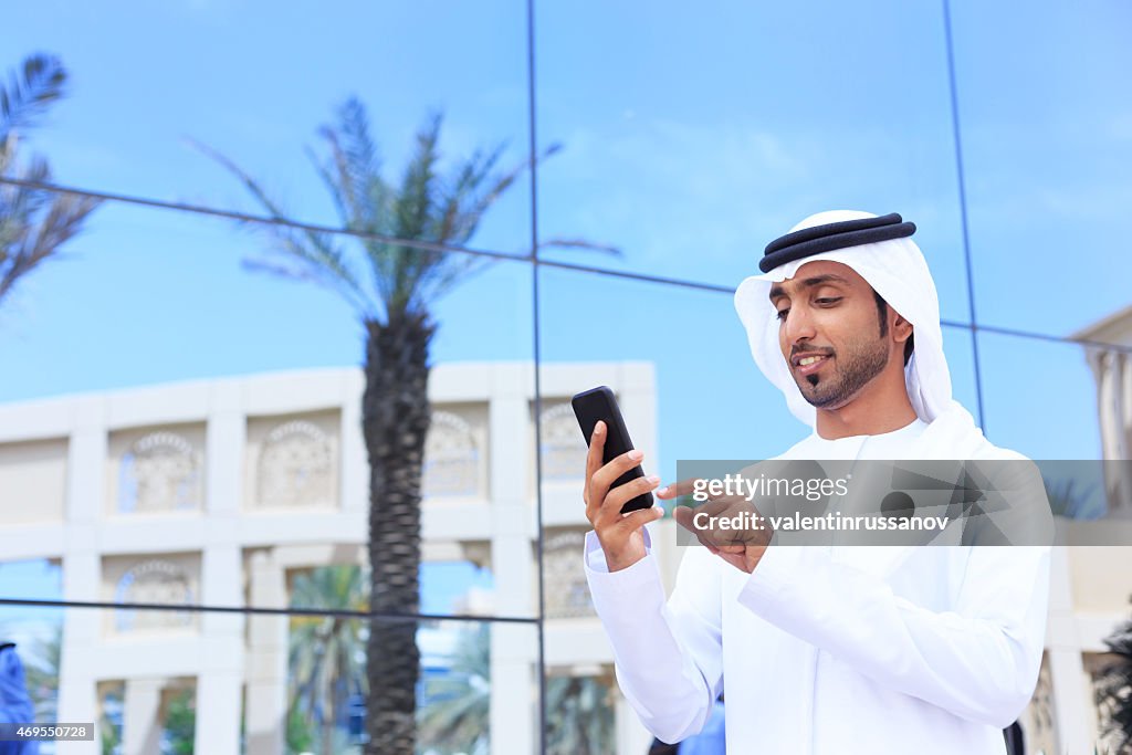 Middle Eastern businessman standing outside
