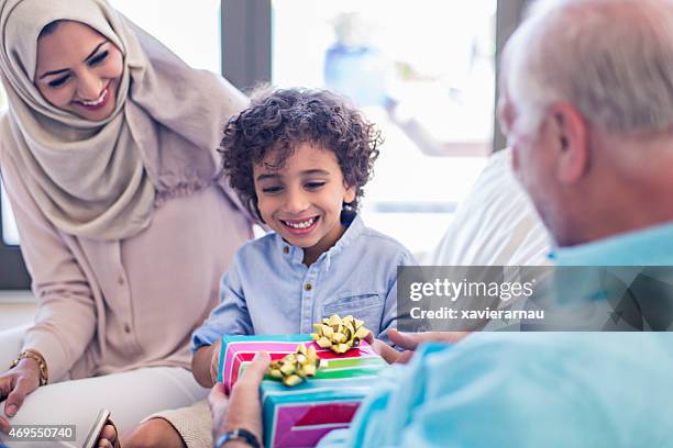 grandfather's birthday gift - muslim boy stockfoto's en -beelden