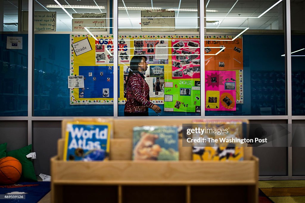 Library intern Jamilla Coleman walks by the new library at DC Prep Benning in Washington...