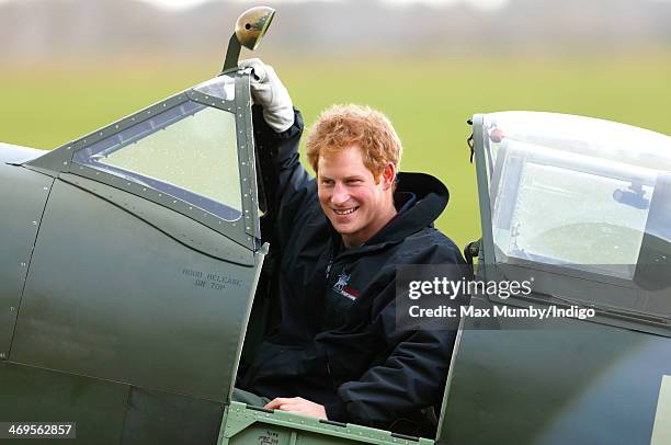 Prince Harry sits in the cockpit of a Spitfire Aircraft during a visit to the Boultbee Flight Academy to launch a scholarship for wounded ex-service...