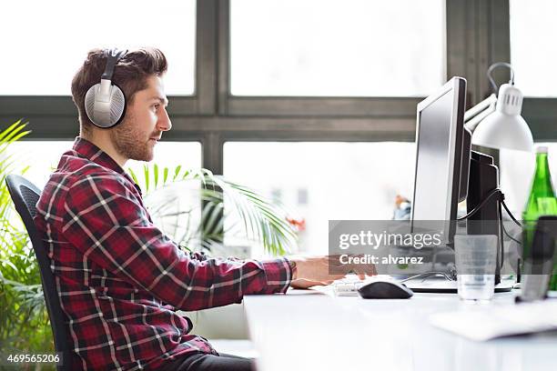 young computer programmer at a startup company - web programmer stock pictures, royalty-free photos & images