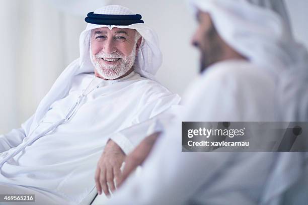 father and son talking - emirati enjoy stock pictures, royalty-free photos & images