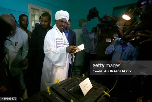 Sudanese President Omar al-Bashir casts his vote in the presidential elections at a polling station in the Saint Francis school in the capital,...