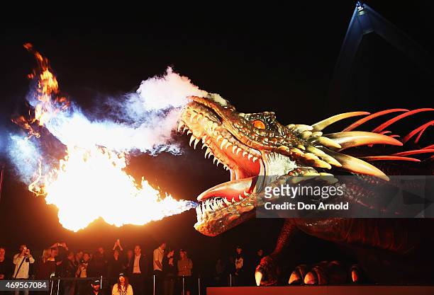 Dragon statue emits fire as people look on the Sydney premiere of "Game Of Thrones" at Sydney Opera House on April 13, 2015 in Sydney, Australia.