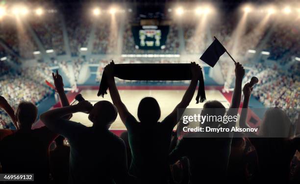 basketball fans at basketball arena - basketball uniform stock pictures, royalty-free photos & images