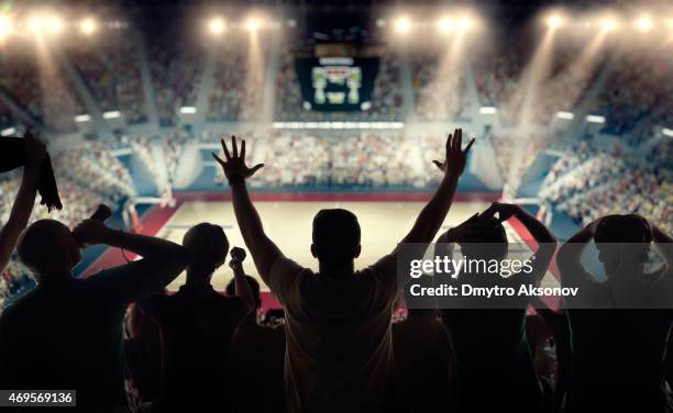 basketball fans at basketball arena - silhouette sports crowd stock pictures, royalty-free photos & images