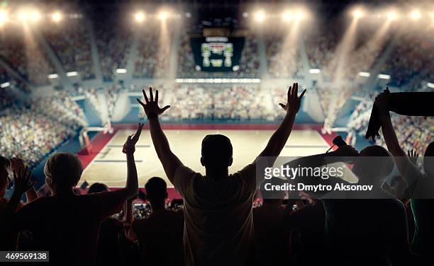basketball fans at basketball arena - basketball sport stock pictures, royalty-free photos & images