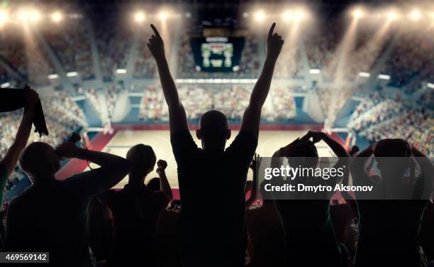 basketball fans at basketball arena - hand fan stock pictures, royalty-free photos & images