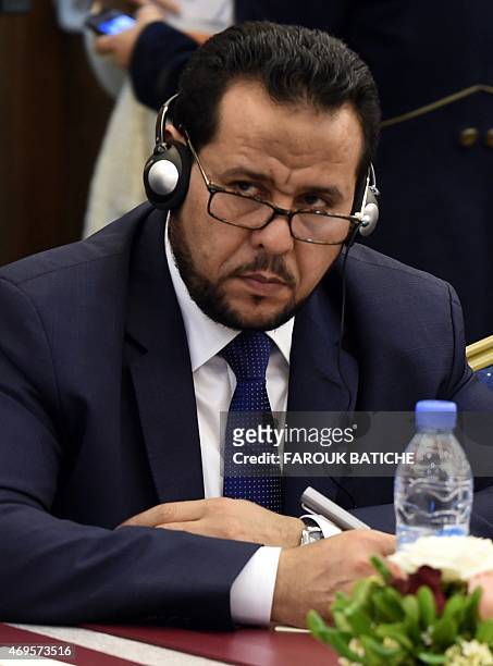 Abdelhakim Belhadj, the leader of Al-Watan Party and former head of the Tripoli Military Council, listens on during talks between Libya's rival...