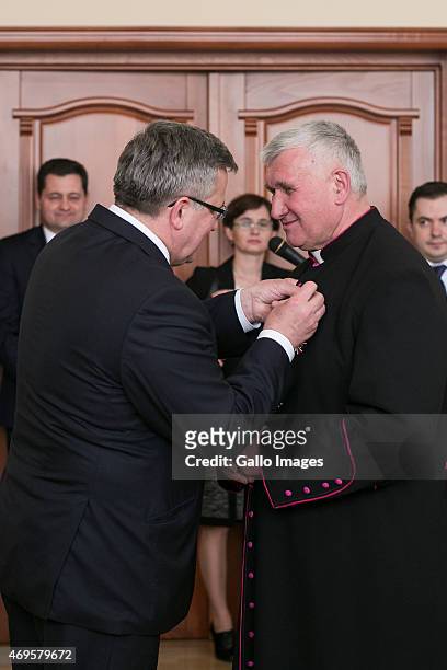 President Bronislaw Komorowski honours Priest Jozef Pawluk during his state visit on April 8, 2015 in Kiev, Ukraine. President Komorowski is on a...