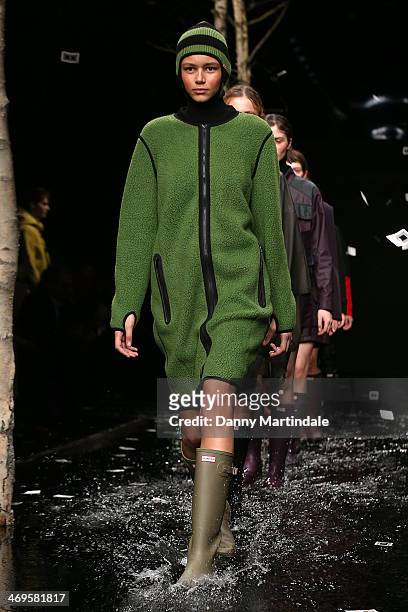 Model walks the runway at the Hunter Original show at London Fashion Week AW14 at University of Westminster on February 15, 2014 in London, England.