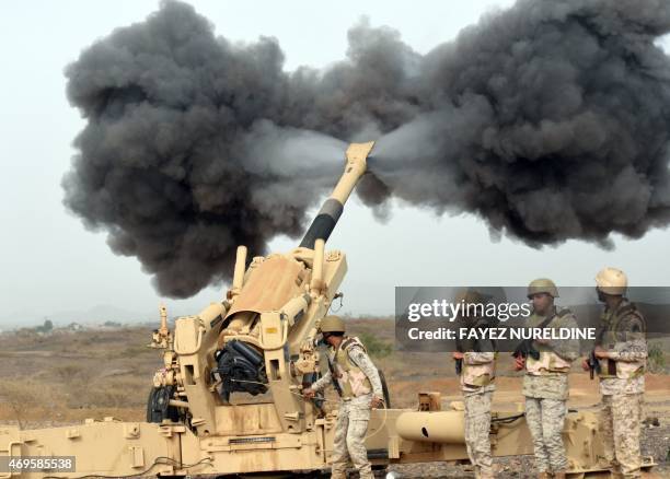 Saudi army artillery fire shells towards Yemen from a post close to the Saudi-Yemeni border, in southwestern Saudi Arabia, on April 13, 2015 . Saudi...