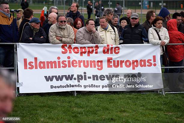 People attend a weekly Pegida demonstration on April 13, 2015 in Dresden, Germany. A large number of supporters and opponents are expected to attend...