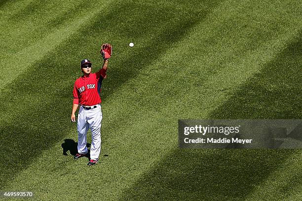 Junichi Tazawa of the Boston Red Sox warms up before the game against the Washington Nationals at Fenway Park on April 13, 2015 in Boston,...