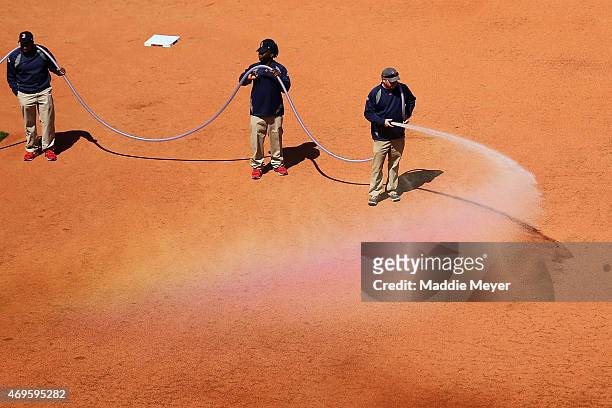 The grounds crew prepares the infield before the game between the Boston Red Sox and the Washington Nationals at Fenway Park on April 13, 2015 in...