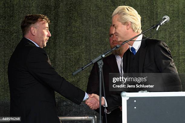 Right-wing Dutch politician Geert Wilders shakes the hand of Pegida organizer Lutz Bachmann at the rally of the Pegida movement at another of their...