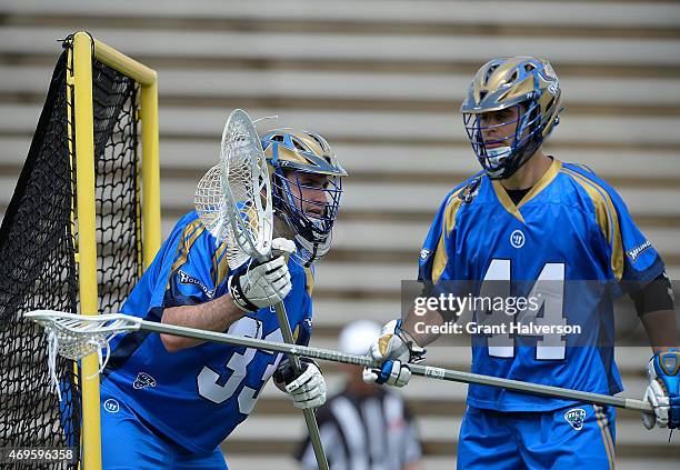 Pierce Bassett and Brett Schmidt of the Charlotte Hounds during their game against the Rochester Rattlers at American Legion Memorial Stadium on...