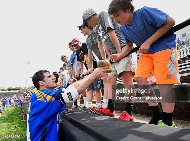 Ryan Flanagan of the Charlotte Hounds signs autographs for fans after their game against the Rochester Rattlers at American Legion Memorial Stadium...