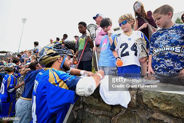 Charlotte Hounds players sign autographs for fans after a game against the Rochester Rattlers at American Legion Memorial Stadium on April 12, 2015...