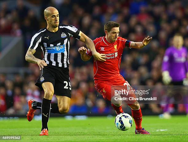 Joe Allen of Liverpool holds off Gabriel Obertan of Newcastle United during the Barclays Premier League match between Liverpool and Newcastle United...