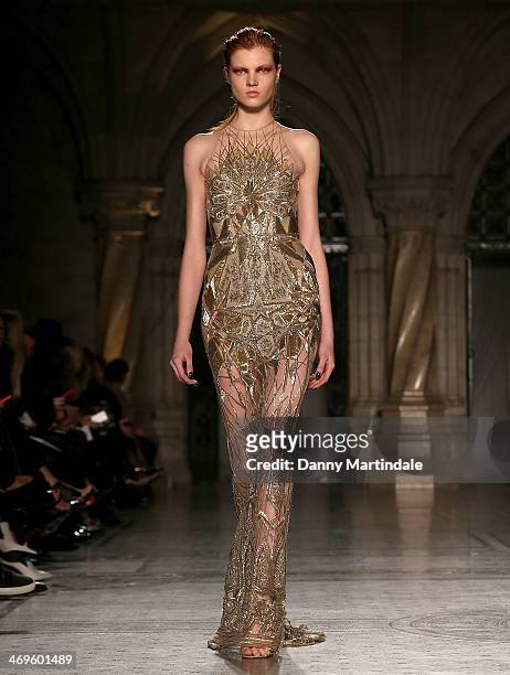 Model walks the runway at the Julien Macdonald show at London Fashion Week AW14 at Royal Courts of Justice, Strand on February 15, 2014 in London,...