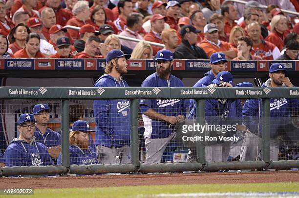 Clayton Kershaw and Brian Wilson of the Los Angeles Dodgers look on from the dugout during Game 3 of the NLDS against the St. Louis Cardinals at...