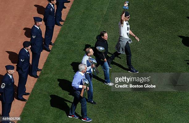Bob Kraft, Jonathan Kraft, Bill Belichick and Tom Brady make their way out to the pitchers mound during the Red Sox home opener at Fenway Park in...