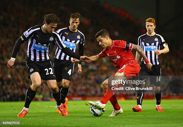 Philippe Coutinho of Liverpool is watched by Ryan Taylor and Daryl Janmaat and Jack Colback of Newcastle United during the Barclays Premier League...