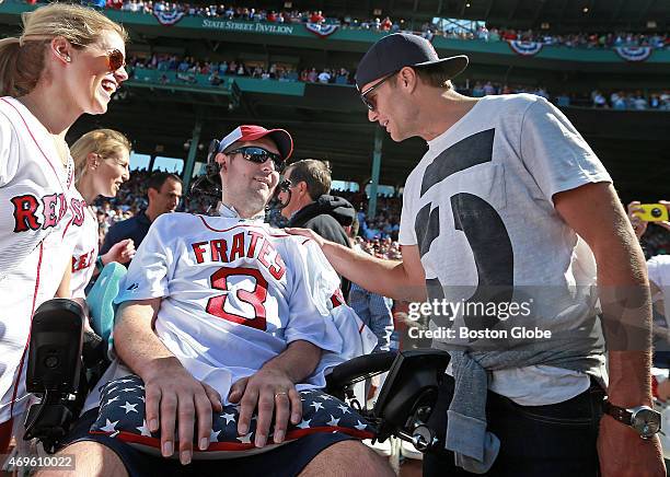 After he threw out the ceremonial first pitch, New England Patriots quarterback Tom Brady, right, greets ALS advocate Pete Frates, center, with...