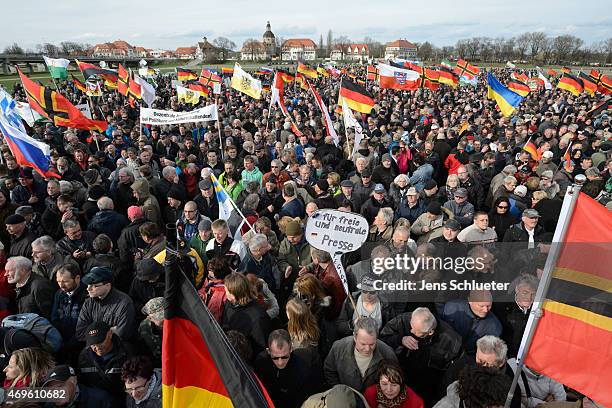 People attend a weekly Pegida demonstration on April 13, 2015 in Dresden, Germany. A large number of supporters and opponents are expected to attend...