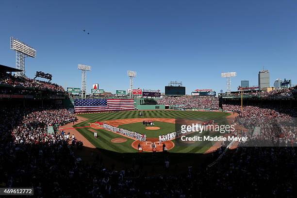 The Boston Red Sox and the Washington Nationals stand on the field for the National Anthem before the game at Fenway Park on April 13, 2015 in...
