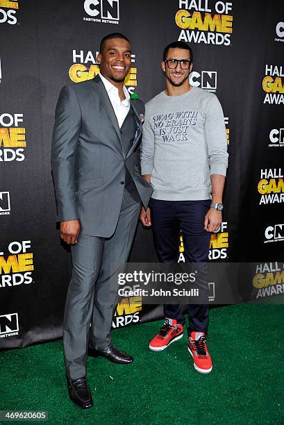 Quarterbacks Cam Newton of the Carolina Panthers and Colin Kaepernick of the San Francisco 49ers poses in the press room during Cartoon Network's...