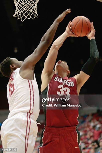 Dwight Powell of the Stanford Cardinal goes to the hoop against Junior Longrus of the Washington State Cougars during the second half of the game at...