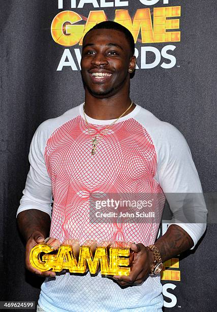 Football player Chris Davis poses with award in the press room during Cartoon Network's fourth annual Hall of Game Awards at Barker Hangar on...