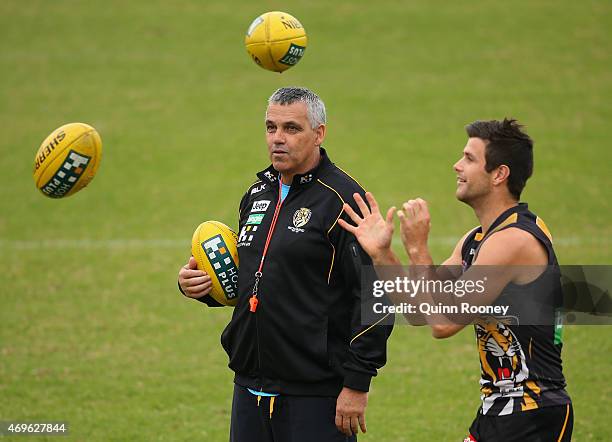 Mark Williams the assistant coach of the Tigers watches on as Trent Cotchin handballs during a Richmond Tigers AFL training session at ME Bank Centre...