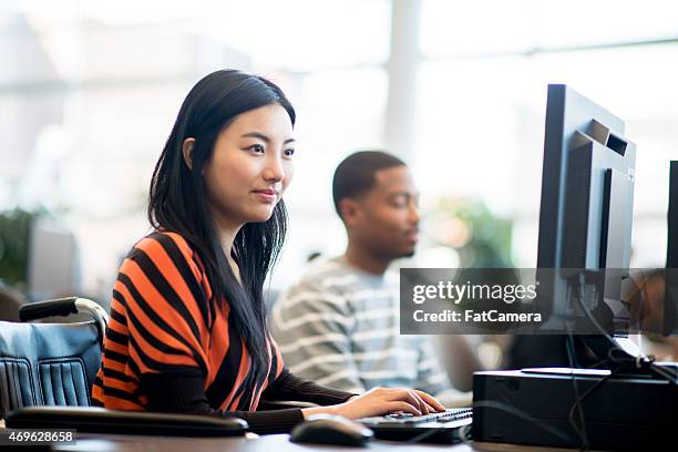handicap student in computer lab. - asian-students-classroom-computer stock pictures, royalty-free photos & images