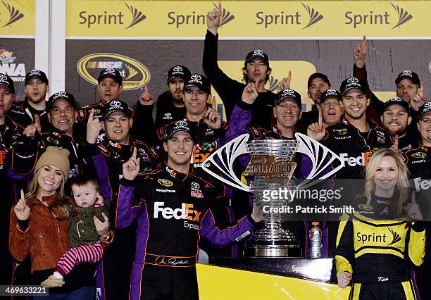 Denny Hamlin, driver of the FedEx Express Toyota, celebrates in Victory Lane with Jordan Fish and daughter Taylor during the NASCAR Sprint Cup Series...